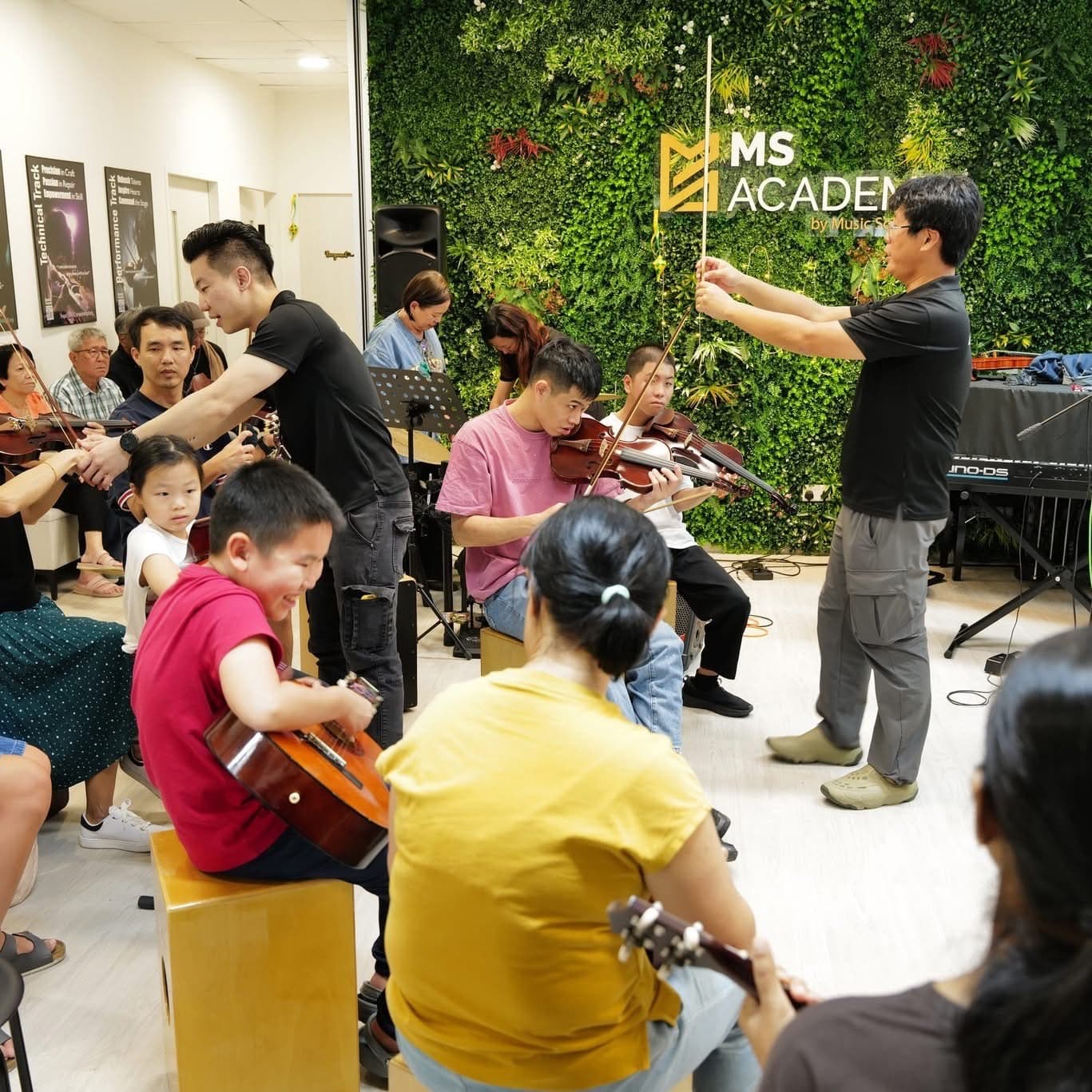 A small string ensemble of violins and cellos rehearsing together